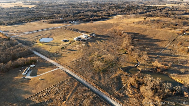 birds eye view of property with a rural view