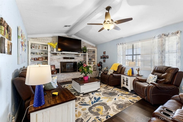 living room with dark wood-type flooring, built in shelves, lofted ceiling with beams, ceiling fan, and a fireplace