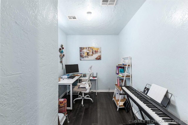 office space with dark wood-type flooring and a textured ceiling