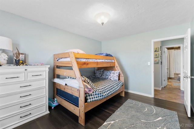 bedroom featuring dark hardwood / wood-style floors and a textured ceiling