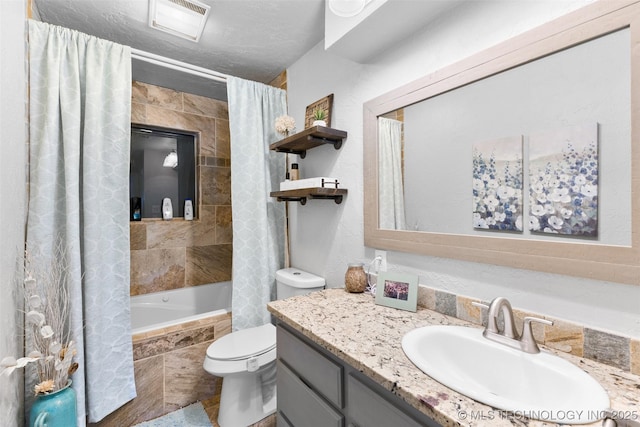 full bathroom with vanity, toilet, a textured ceiling, and shower / bath combo