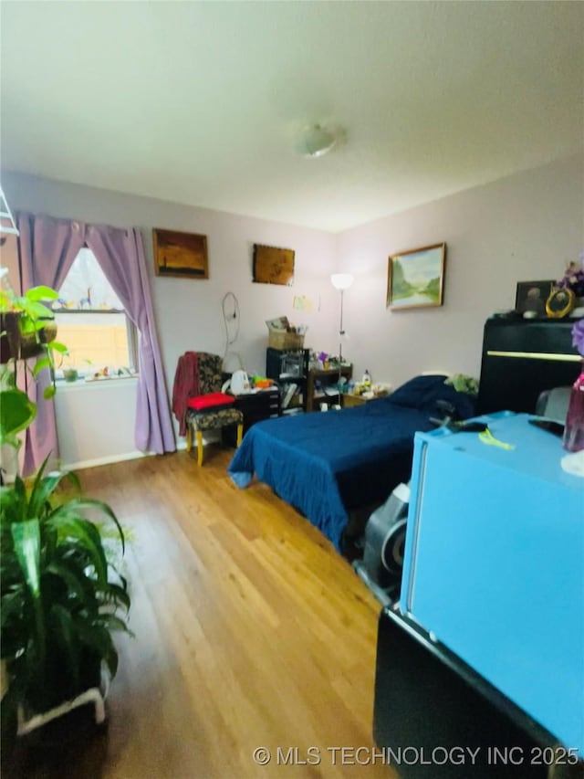 bedroom with wood-type flooring