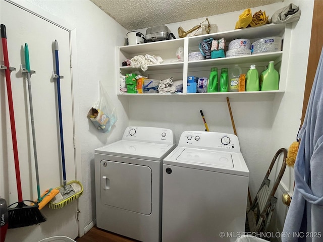 laundry room featuring washing machine and dryer and a textured ceiling