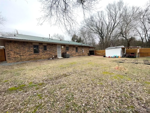 view of yard with central AC and a storage unit