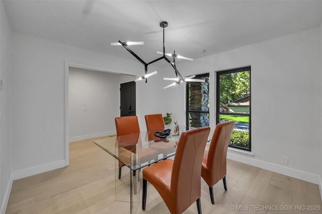 dining room with a chandelier and light hardwood / wood-style flooring