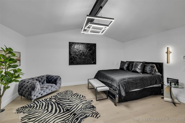 bedroom with light hardwood / wood-style flooring and vaulted ceiling