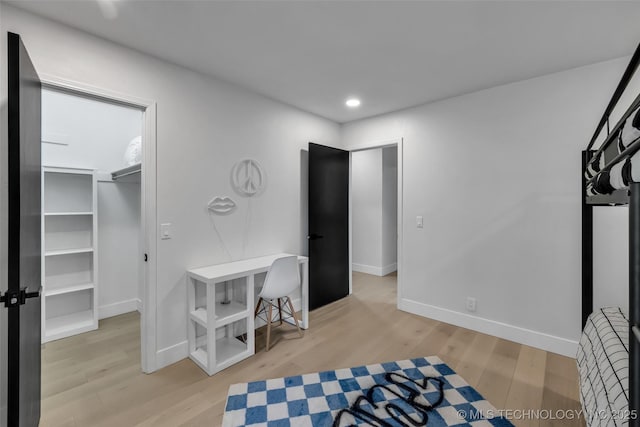 interior space featuring a walk in closet and light wood-type flooring