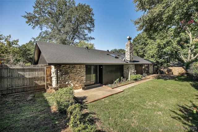 rear view of property featuring a yard and a patio