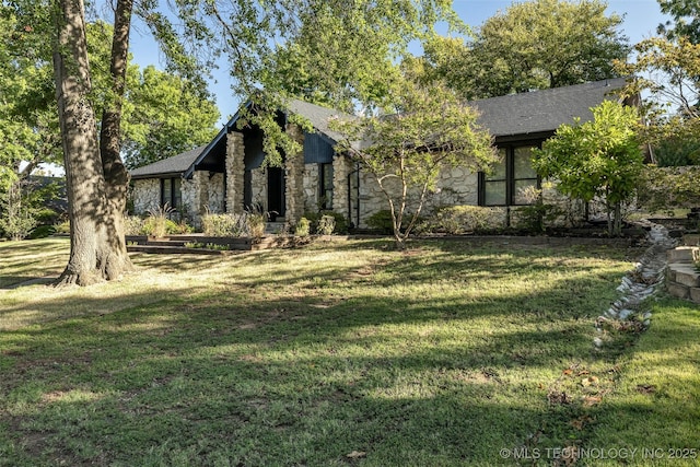 obstructed view of property with a front lawn