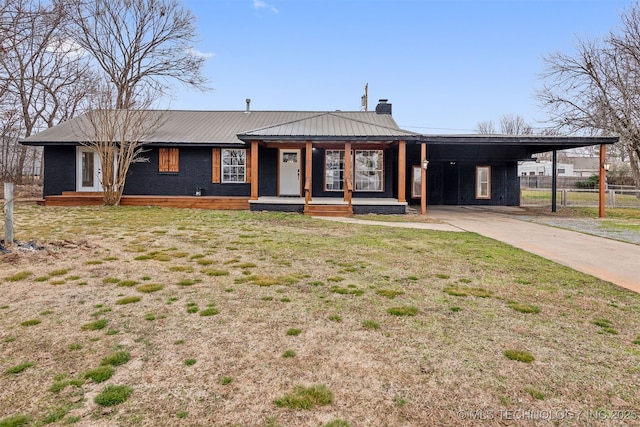 31915 E 723rd Dr, Wagoner, OK 74467 - view of front of property featuring a chimney, driveway, an attached carport, metal roof, and covered porch
