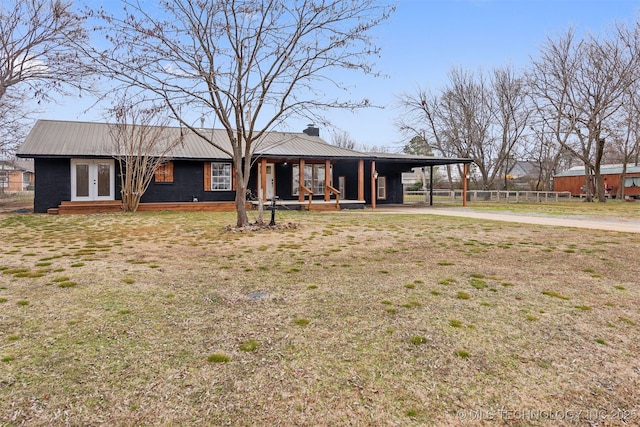 view of front of house featuring french doors, a carport, and a front yard