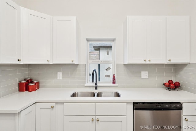 kitchen with dishwasher, sink, white cabinets, and backsplash