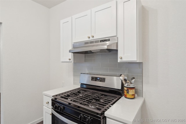 kitchen with tasteful backsplash, gas stove, and white cabinets