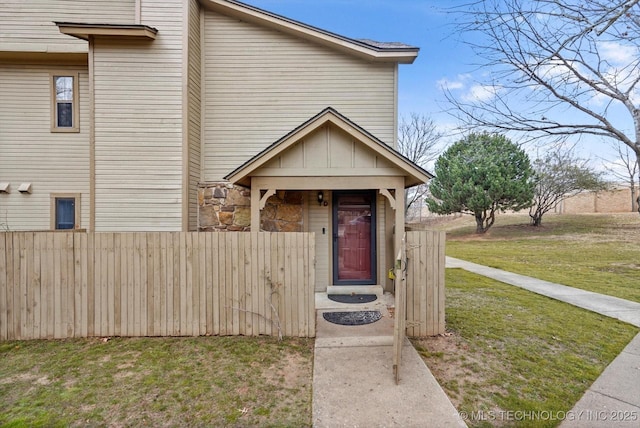 doorway to property featuring a lawn