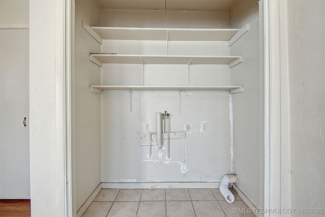 laundry area with washer hookup, light tile patterned floors, and hookup for an electric dryer