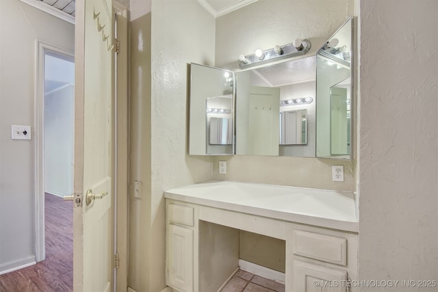 bathroom featuring vanity and ornamental molding