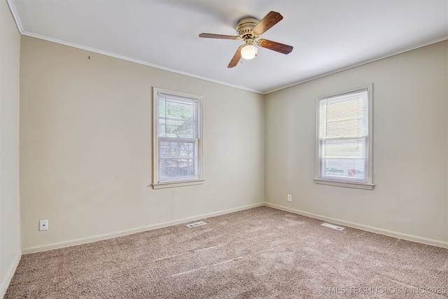 unfurnished room with crown molding, carpet flooring, and ceiling fan