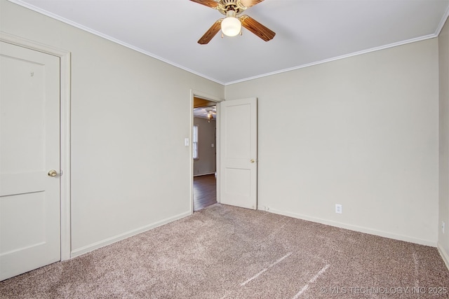 carpeted empty room featuring ornamental molding and ceiling fan