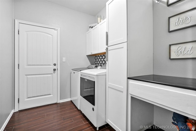 clothes washing area with cabinets, dark hardwood / wood-style floors, and washing machine and dryer