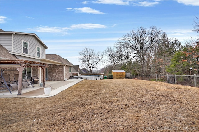 view of yard with a patio, a pergola, a jacuzzi, and a shed