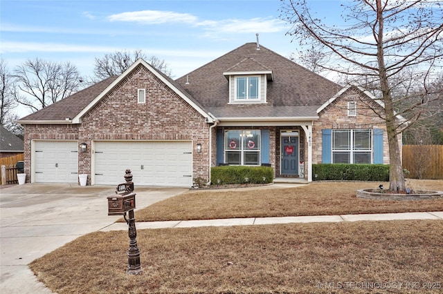 view of front of home with a garage and a front yard