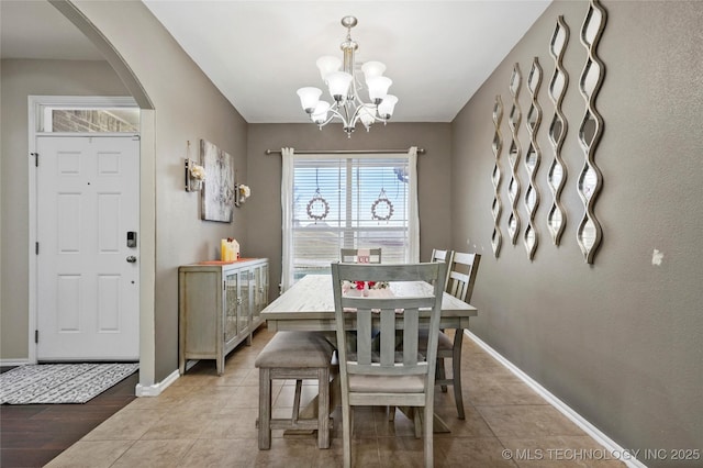 dining room featuring an inviting chandelier and light tile patterned floors