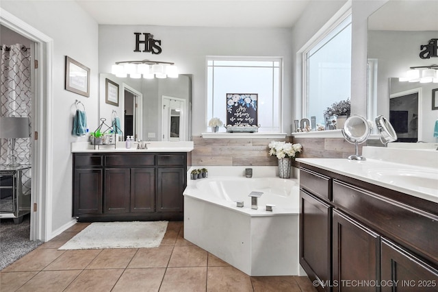 bathroom with vanity, tile patterned flooring, and a bathtub