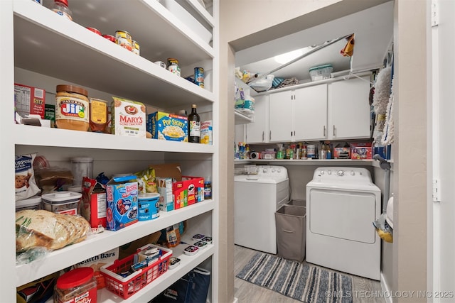 laundry area with cabinets and independent washer and dryer