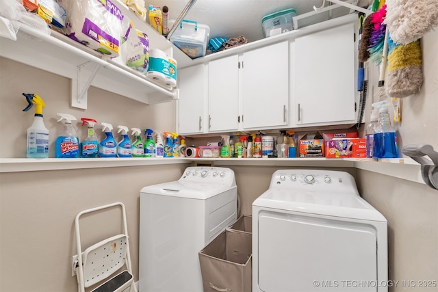 washroom with cabinets, washer and clothes dryer, and sink