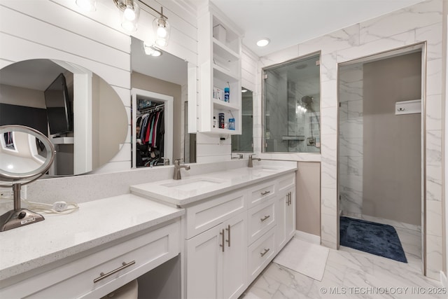 bathroom with tiled shower and vanity