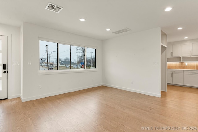 unfurnished living room featuring light wood-type flooring