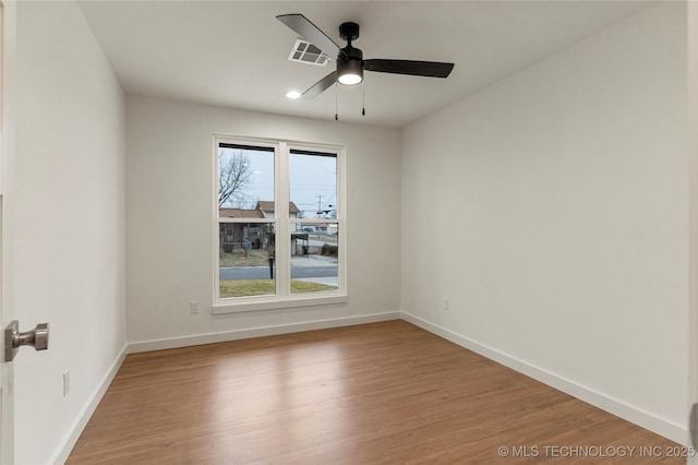 empty room featuring hardwood / wood-style floors and ceiling fan