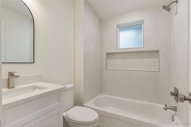 full bathroom featuring tiled shower / bath combo, vanity, and toilet