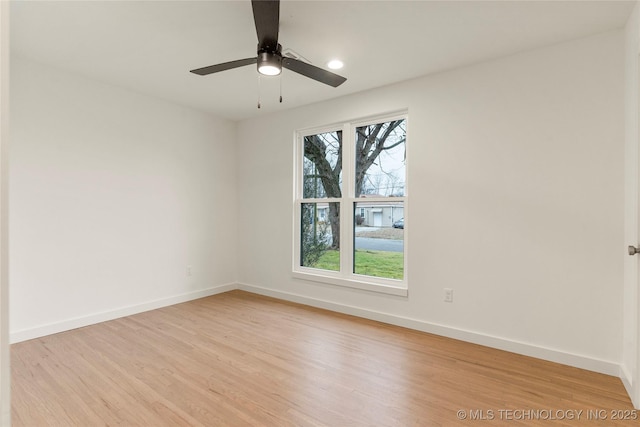 unfurnished room featuring ceiling fan and light hardwood / wood-style floors