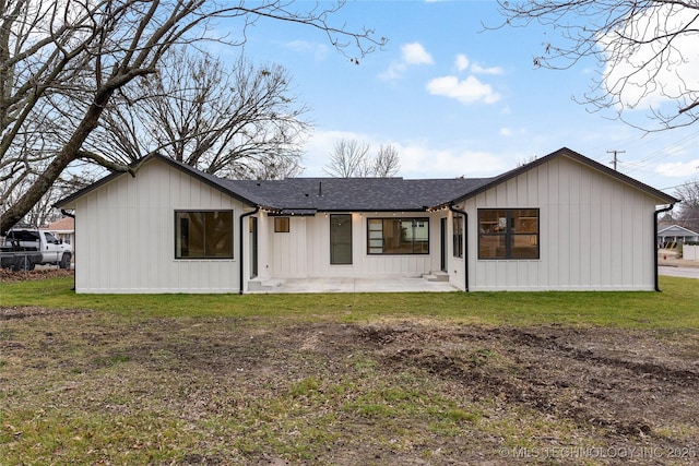 rear view of house with a yard and a patio area