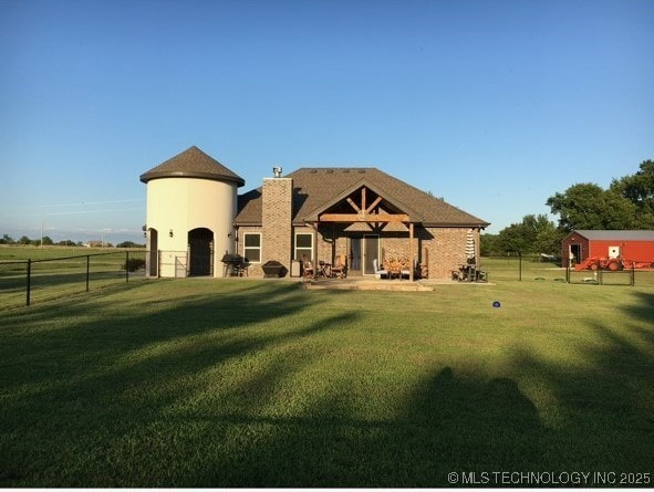 rear view of property featuring a lawn