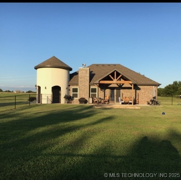 back of property with a lawn