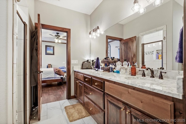 bathroom with vanity, a shower with door, and ceiling fan