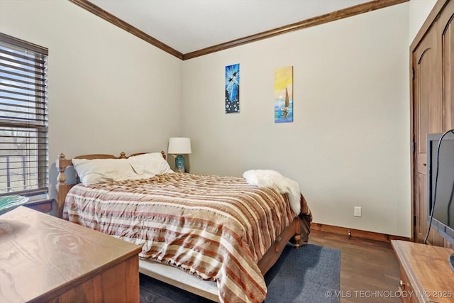 bedroom featuring crown molding and dark hardwood / wood-style floors