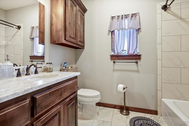 full bathroom featuring tiled shower / bath, vanity, and toilet