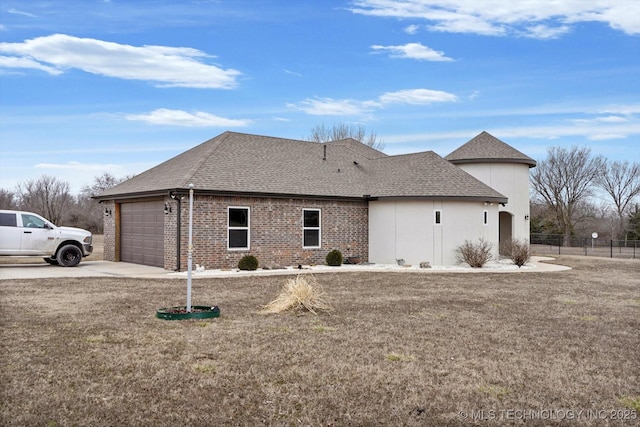 view of side of home featuring a garage and a yard