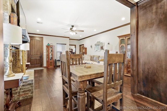 dining room featuring ceiling fan, ornamental molding, and dark hardwood / wood-style flooring