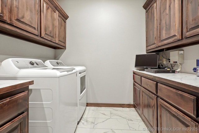 clothes washing area featuring cabinets and independent washer and dryer