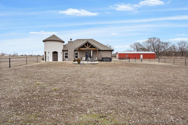 view of front facade with a rural view