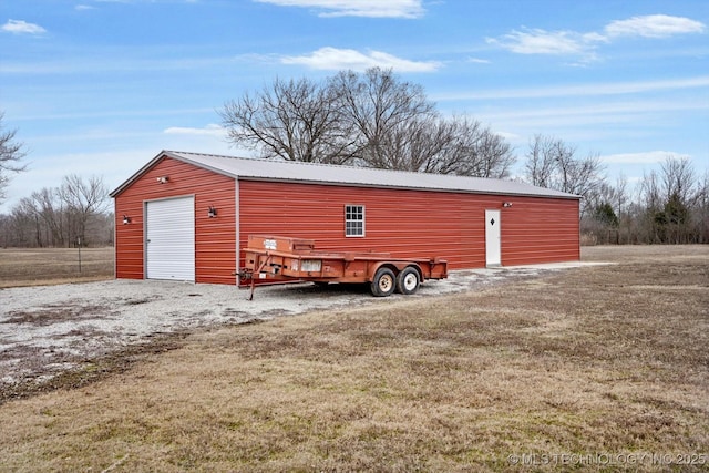 view of outbuilding with a garage and a lawn