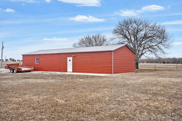 view of outbuilding with a yard