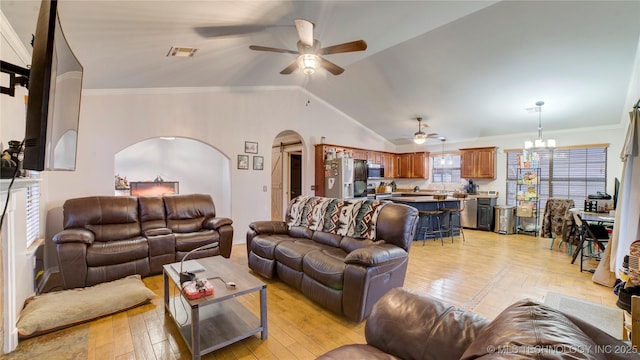 living room featuring vaulted ceiling, crown molding, ceiling fan with notable chandelier, and light wood-type flooring