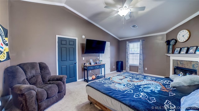 carpeted bedroom with ceiling fan, ornamental molding, lofted ceiling, and a tile fireplace