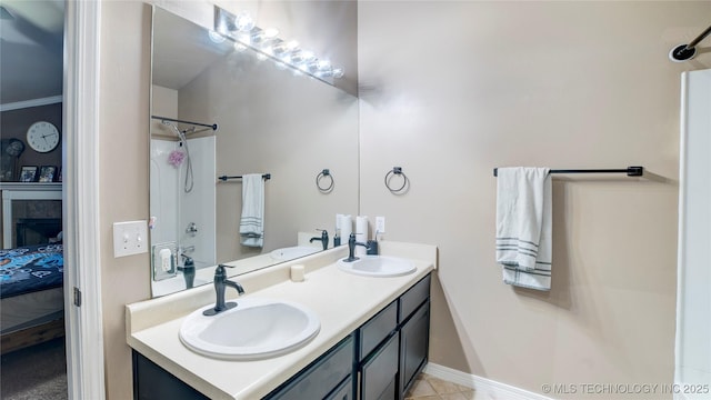 bathroom with a tile fireplace and vanity