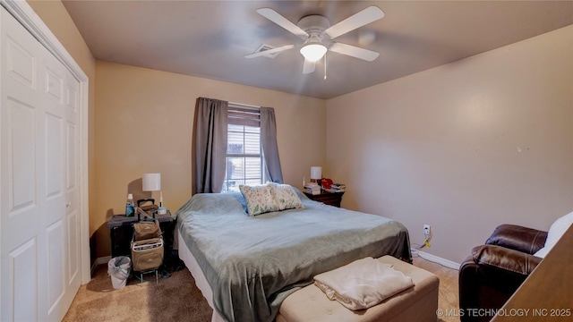 carpeted bedroom featuring ceiling fan and a closet